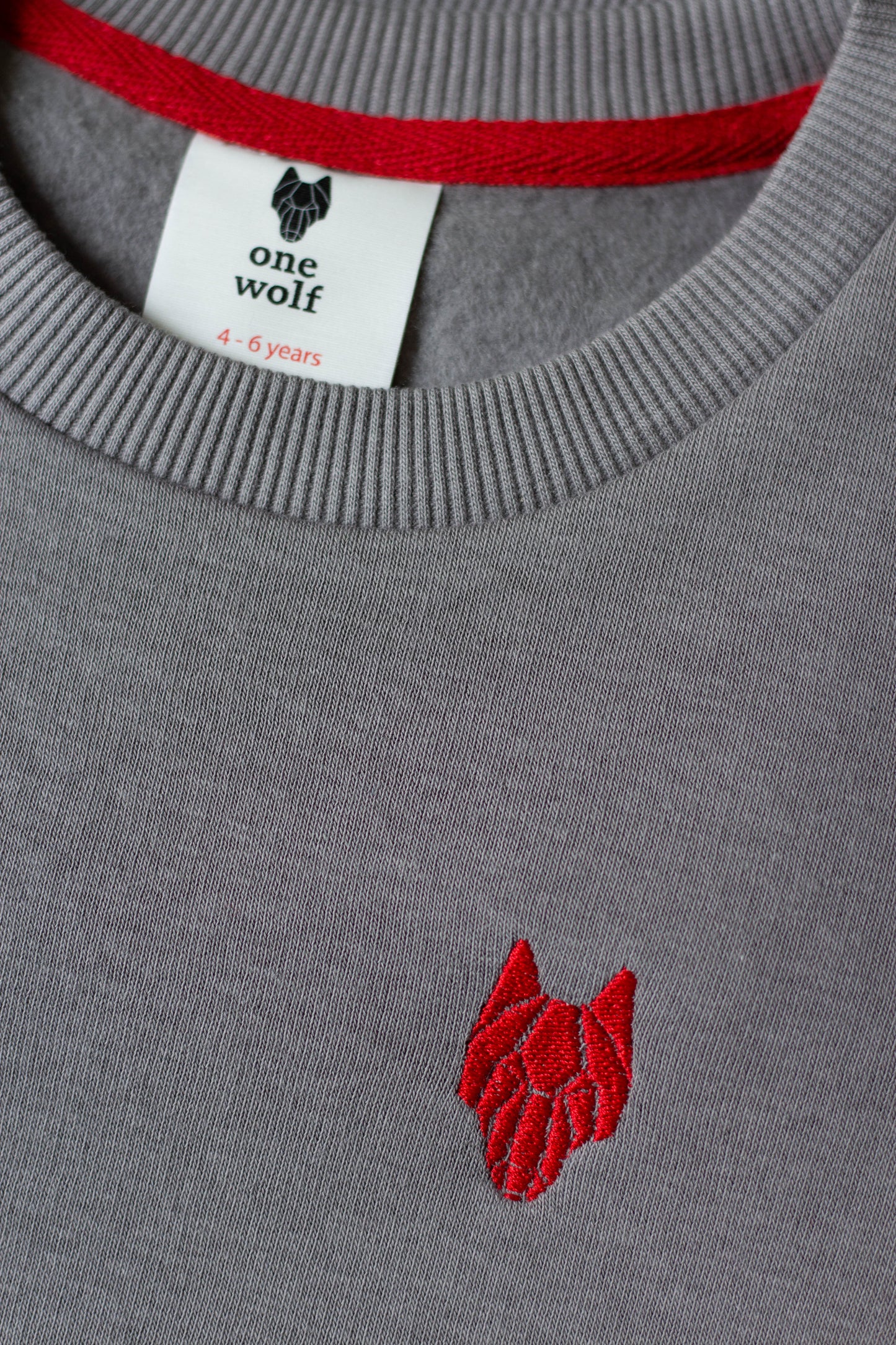 Kid’s One Wolf sweater, grey with red logo