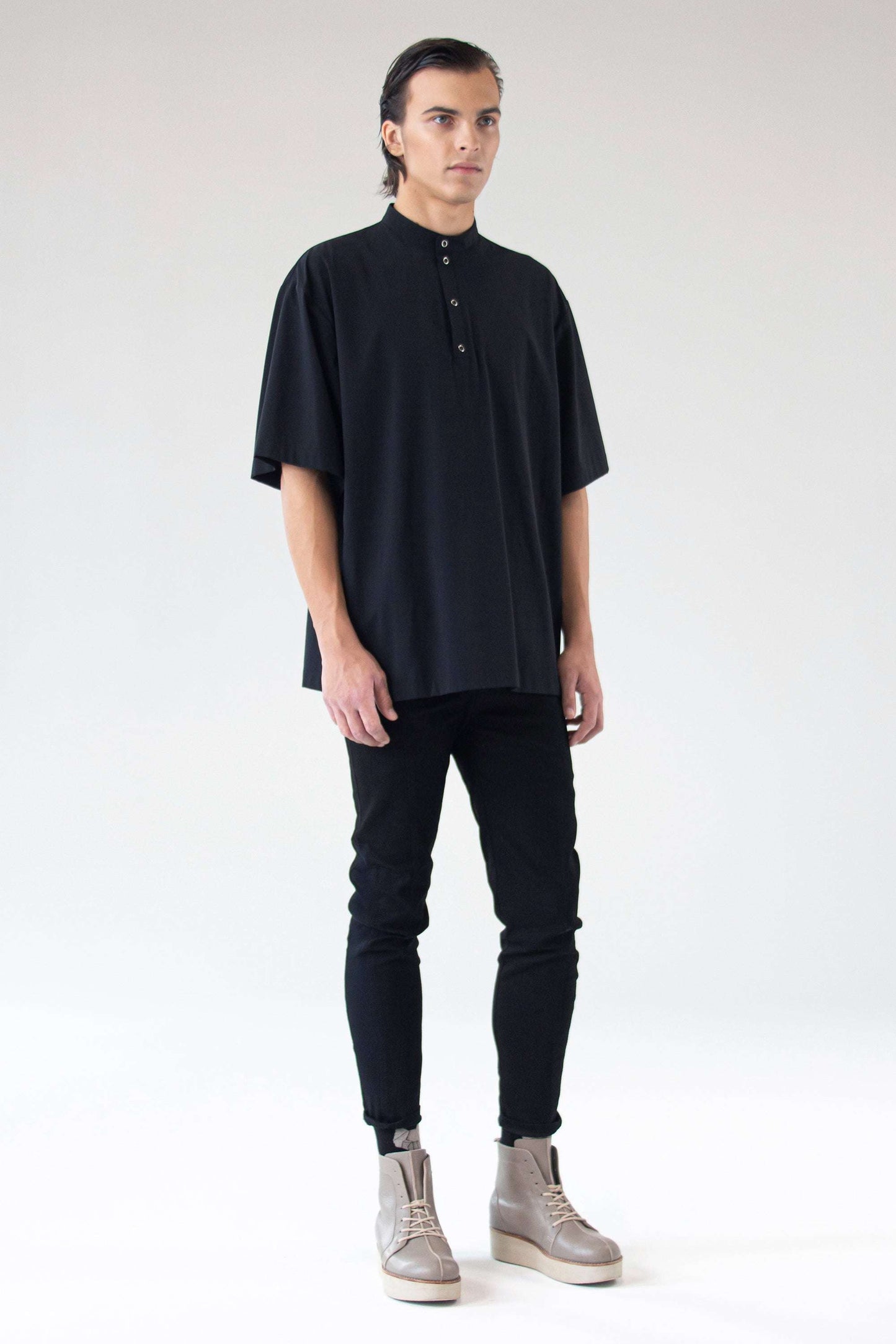 Model wearing unisex oversized black short-sleeve shirt Holy, front view