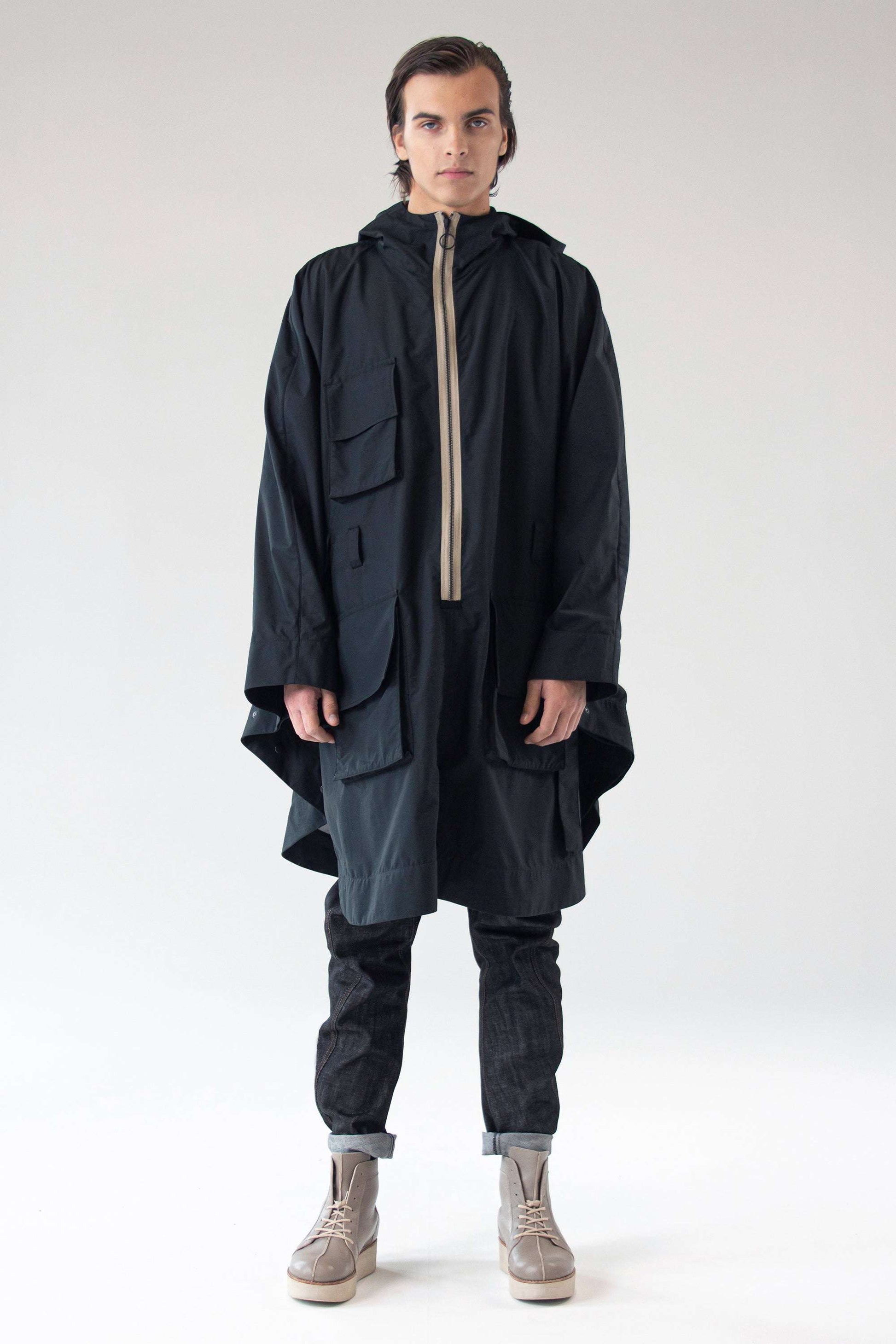 Unisex waterproof Poncho SEEKER by One Wolf, full-length front view on male model.