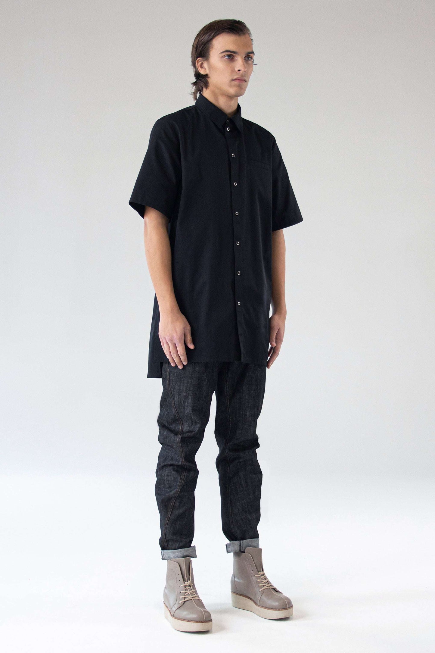 Model wearing One Wolf Shirt Seeker in black, front view, unisex cotton shirt